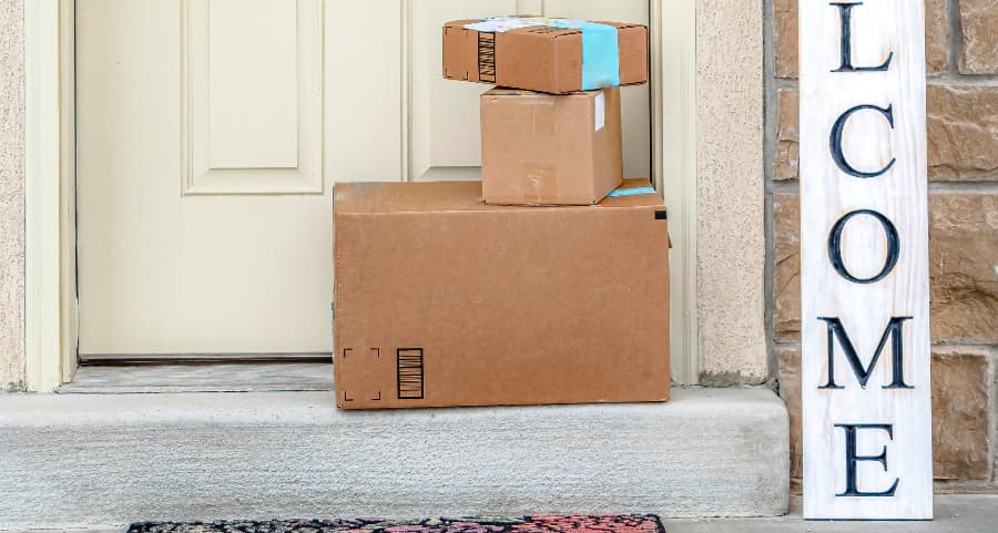 Deliveries on the front porch of a house with a welcome sign in Ogden